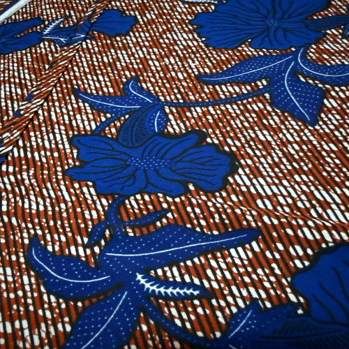 Close-up of fabric with blue floral patterns on a brown background