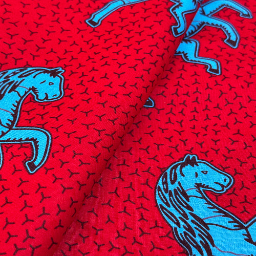 Red fabric with blue dinosaur patterns