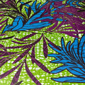 Tropical leaf pattern with blue and purple leaves on a green background