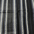 Black and white striped pattern with geometric shapes on a textured background