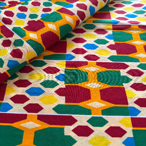 Colorful geometric patterned fabric with hexagonal shapes.