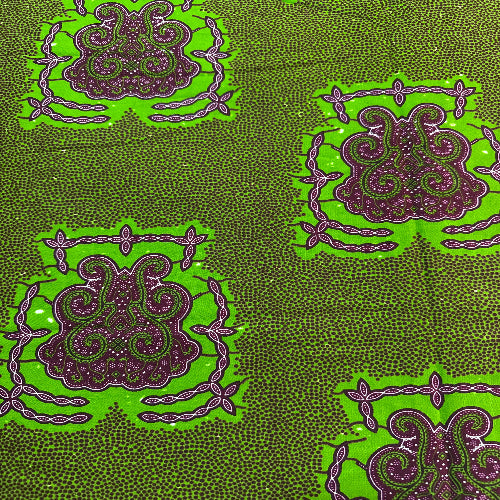 Patterned fabric with green and purple design on a green background