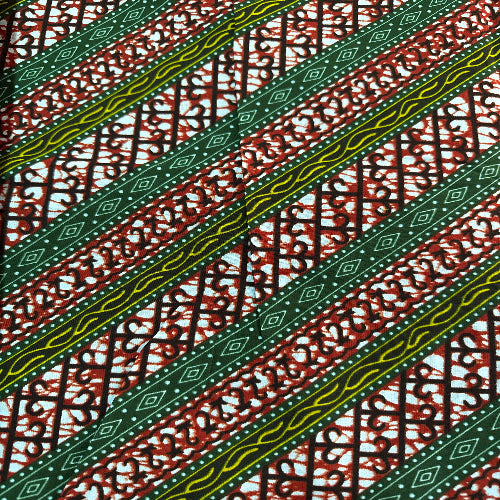 Patterned fabric with green and yellow stripes on a red and white background
