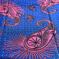 Pink paisley design on a blue patterned background