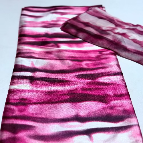 Pink and purple tie-dye fabric on a light blue background