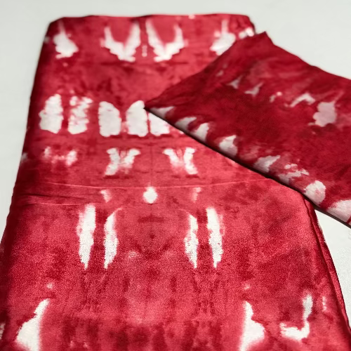 Red and white tie-dye fabric on a white background