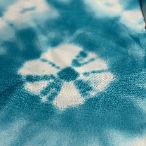 Close-up of tie-dye fabric with blue and white pattern