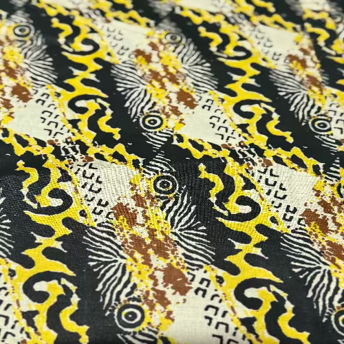 Close-up of a fabric with intricate black, yellow, and brown pattern