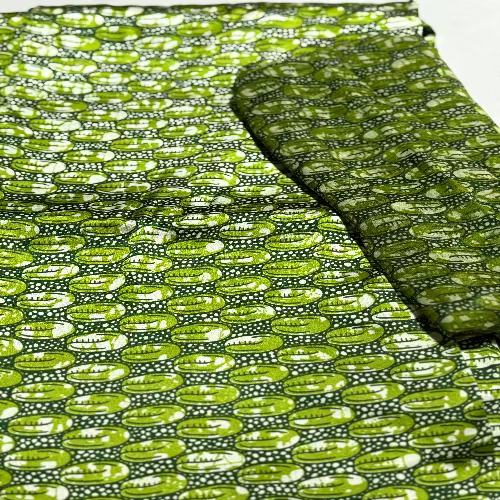 Green fabric with a pattern of green shapes on a white background