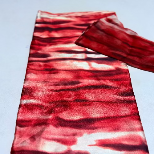 Red and black patterned fabric on a light blue background