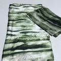 Green and white striped fabric on a light gray background