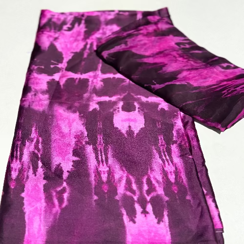 Purple and black tie-dye fabric on a white background