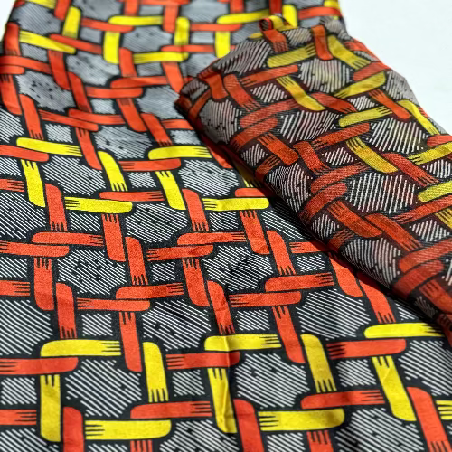 Two patterned ties with red, yellow, and gray design on a white background