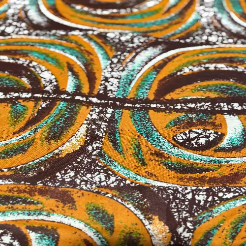 Close-up of a patterned fabric with orange, green, and black colors.