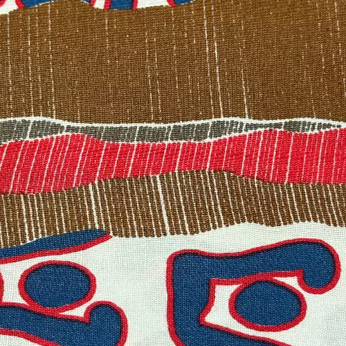 Close-up of fabric with brown, red, and blue pattern