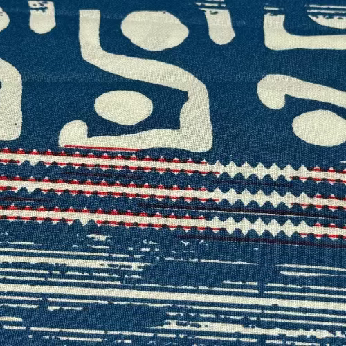 Textile with abstract patterns in blue, white, and red on a blue background