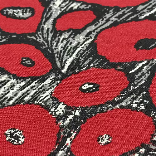 Close-up of red floral pattern with black and white accents on a red background