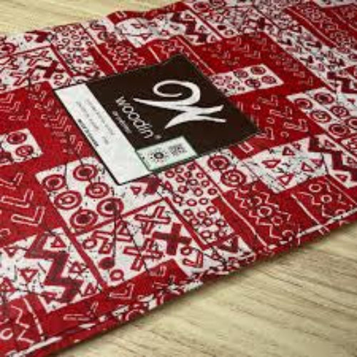 Red patterned fabric with a brand label on a wooden surface