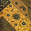 Traditional batik pattern with black designs on a yellow background