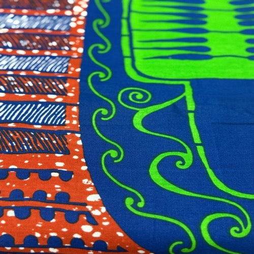 Close-up of colorful fabric with patterns in blue, green, and red.