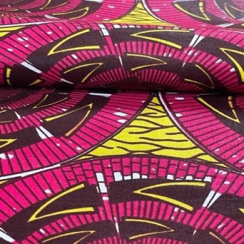 Roll of fabric with pink, yellow, and black geometric pattern
