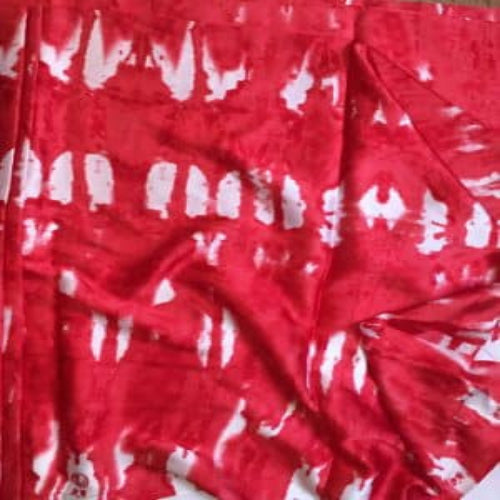 Red fabric with white patterns, possibly a dress or garment.