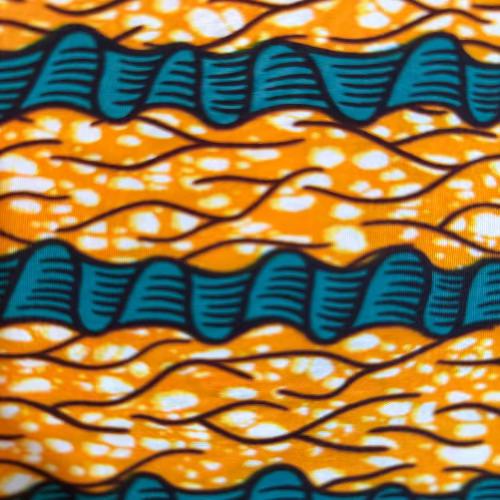 African fabric print with blue and white patterns on a yellow background
