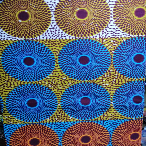 Patterned fabric with circular designs in blue, yellow, and purple.