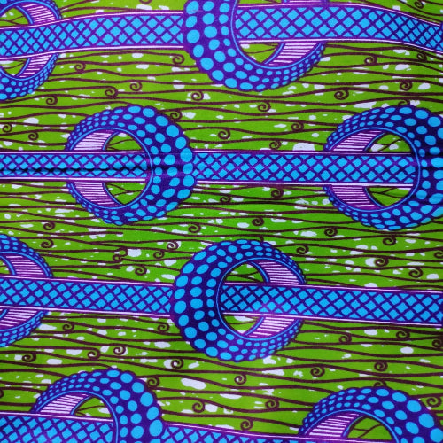 Patterned fabric with blue and purple designs on a green background