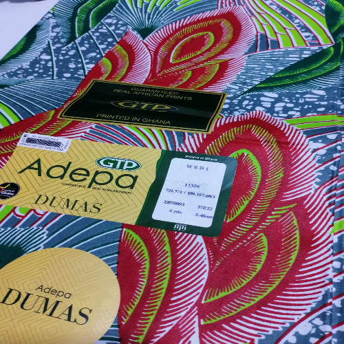 Colorful fabric with GTP and Adepa branding on a patterned background