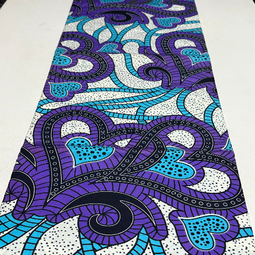Close-up of a fabric with blue and purple abstract pattern on a white background