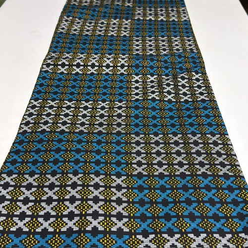 Patterned fabric with blue, black, and white design on a white background