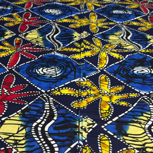 Colorful fabric with abstract patterns in blue, yellow, and red on a dark background