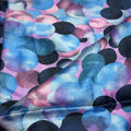 Fabric with blue, pink, and black abstract pattern