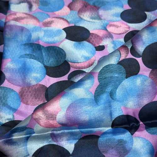Fabric with blue, pink, and black abstract pattern
