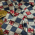 Close-up of patterned fabric with red, blue, and white design