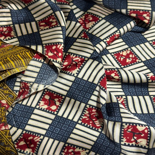 Close-up of patterned fabric with red, blue, and white design