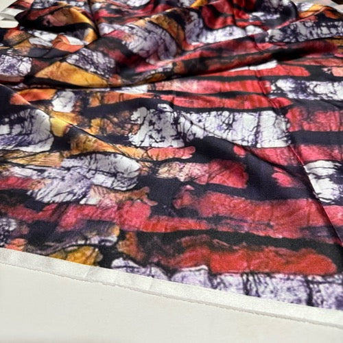 Close-up of colorful fabric with an abstract pattern on a white background
