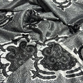 Black paisley pattern on white fabric
