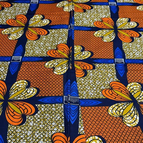 Colorful fabric with butterfly pattern featuring orange, blue, and yellow colors.