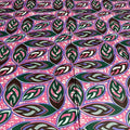Patterned fabric with leaf design on a pink background