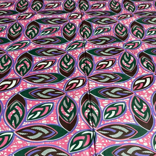 Patterned fabric with leaf design on a pink background