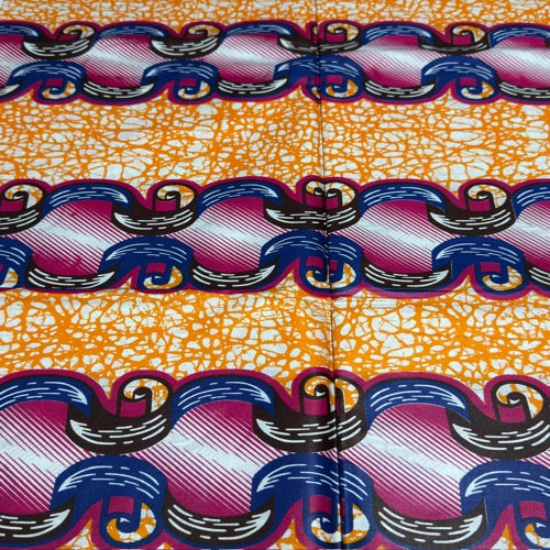 Colorful fabric with a pattern of wavy lines on an orange background