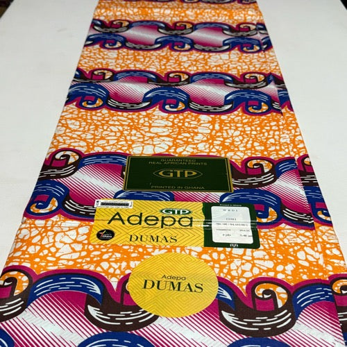 Colorful fabric with patterns and visible brand labels on a white background