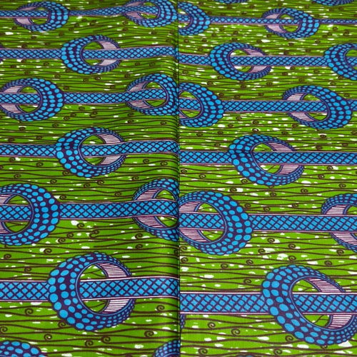 Patterned fabric with blue and green design on a green background