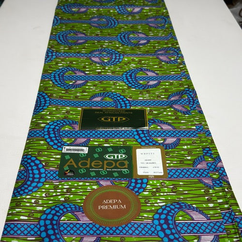 African fabric with blue and green patterns on a white background, featuring GTP and Adepa branding.